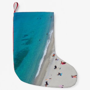 Bird's eye view photo of people on beach small christmas stocking