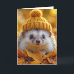 Birthday Hedgehog In Autumn Leaves Card<br><div class="desc">A delightful hedgehog wears a warm,  knitted hat while nestled among vibrant autumn leaves.
All text can be changed.</div>