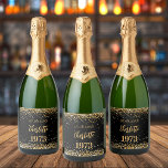 Birthday party black gold year born sparkling wine label<br><div class="desc">A black background decorated with golden confetti. The text: The name is written in dark rose gold with a large modern hand lettered style script. Personalise and add a date,  name and year of birth.</div>