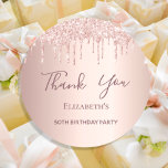 Birthday Party rose gold pink glitter Thank You Classic Round Sticker<br><div class="desc">A sticker for a girly and glamorous 50th (or any age) birthday party. A rose gold background with an elegant rose gold and pink faux glitter drips, paint drip look. The text: Thank You is written in dark rose gold with a large modern hand lettered style script. Tempate for a...</div>