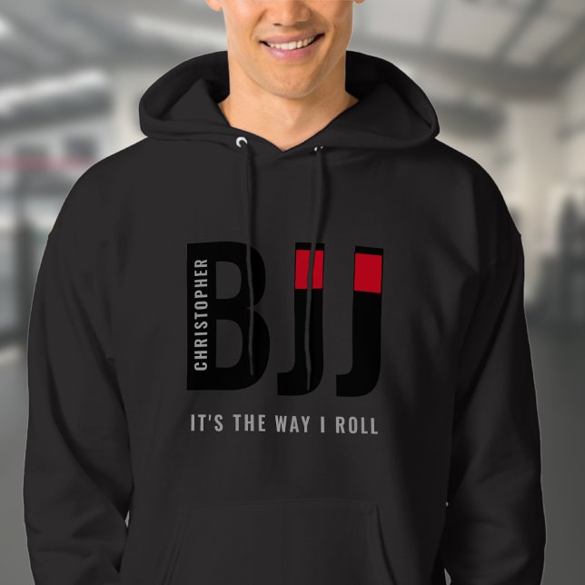BJJ Brazilian Jiu Jitsu Add Name Black Belt Hoodie (Unisex black BJJ hoodie worn by male model in a gym.)