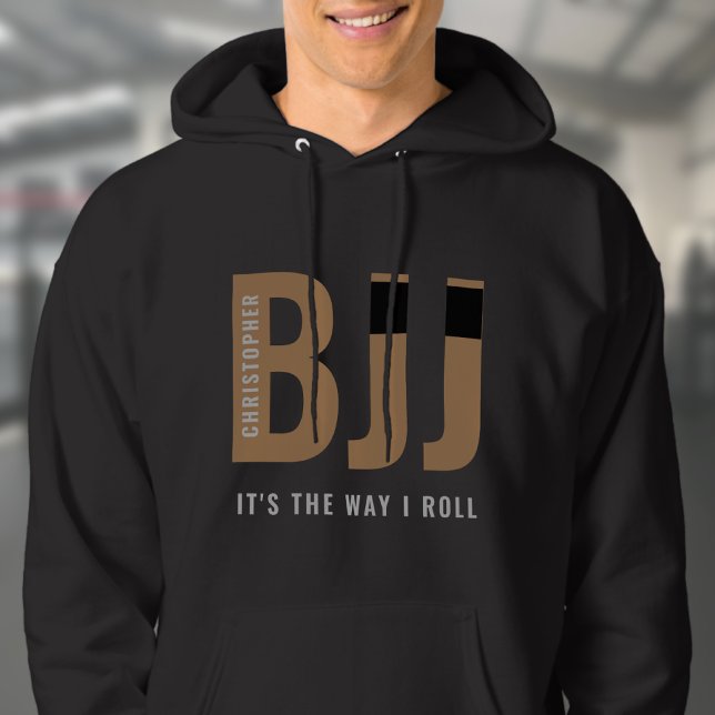 BJJ Brazilian Jiu Jitsu Add Name Brown Belt Hoodie (Brown Belt Black hoodie worn by male model in a gym.)