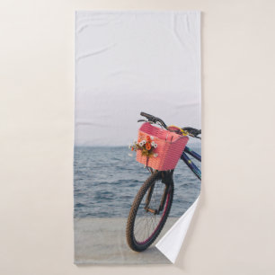Black and blue bicycle with basket bath towel