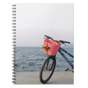 Black and blue bicycle with basket notebook