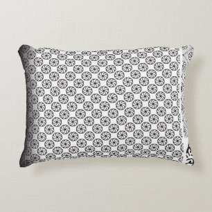 Black and white fabric design featuring intricate  decorative cushion