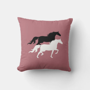 Black and white horse silhouettes on rose gold cushion