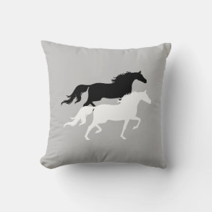 Black and white horse silhouettes on silver grey cushion