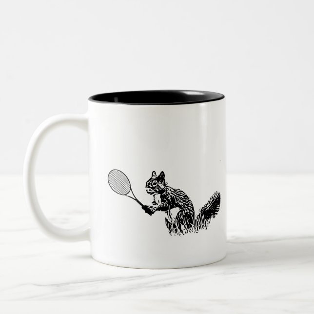 Black and White Squirrel With Tennis Racket Two-Tone Coffee Mug (Left)