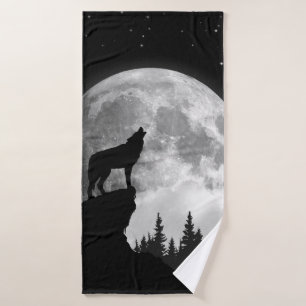 Black and white wolf howling at the moon bath towel