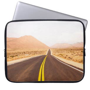 BLACK ASPHALT ROAD IN THE MIDDLE OF BROWN FIELD LAPTOP SLEEVE
