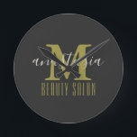 Black Beauty Salon by Anastasia Monogram Round Clock<br><div class="desc">Black Beauty Salon by Anastasia Monogram Round Clock. Gold monogram letter with name of business and owner on black background. Customise it with your own information.  @Miri Creations - Created For You Only with You In Mind!
 Copyright Miri Creations,  all rights reserved.</div>