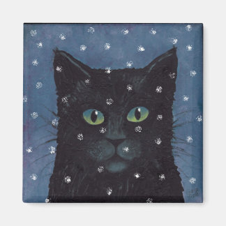 black cat in winter snow magnet