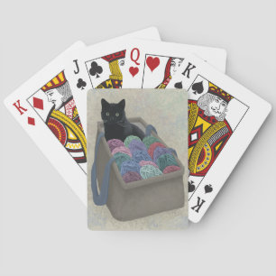Black cat in yarn bag  playing cards