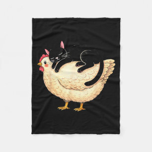 Black cat sleeping on chicken fleece blanket