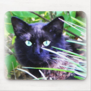 Black cat with striking green eyes mouse pad