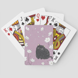 Black cat with white flowers playing cards