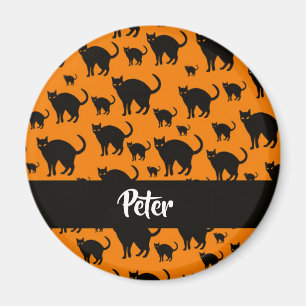 Black cats on orange magnet