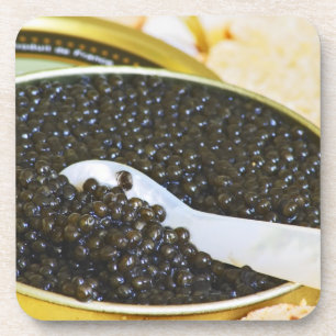 Black caviar and a spoon of mother-of-pearl to coaster