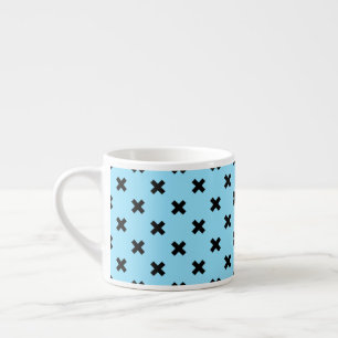 Black cross stitches on baby blue espresso cup