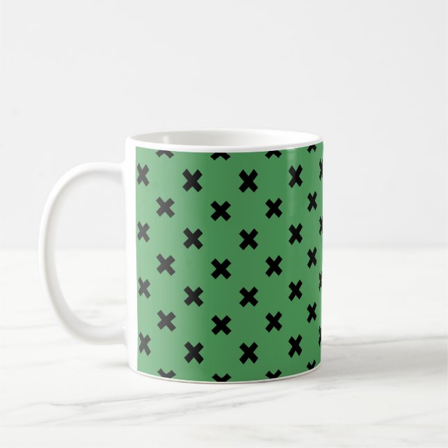 Black cross stitches on green coffee mug (Left)