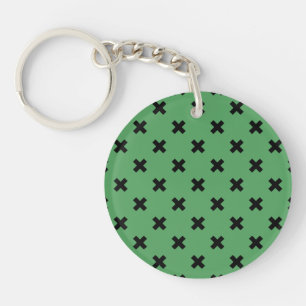 Black cross stitches on green key ring
