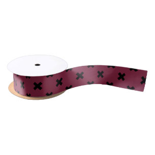 Black cross stitches on mulberry satin ribbon