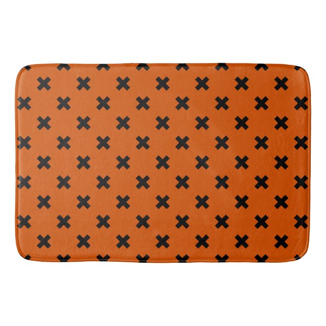 Black cross stitches on orange bath mat (Front)