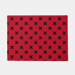 Black cross stitches on red doormat