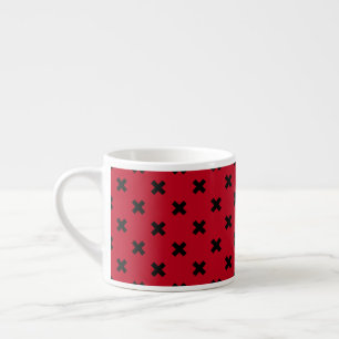 Black cross stitches on red espresso cup