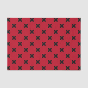 Black cross stitches on red tissue paper