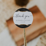 Black Gold Agate Wedding Thank You Classic Round Sticker<br><div class="desc">This elegant modern wedding sticker features a black watercolor agate geode design trimmed with faux gold glitter. The words "thank you" appear in handwriting calligraphy with swashes at the beginning and end. Add the couple's names and wedding date below.</div>