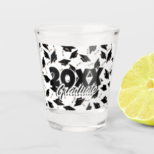 Black Graduation Caps Tossed in the Air on White Shot Glass