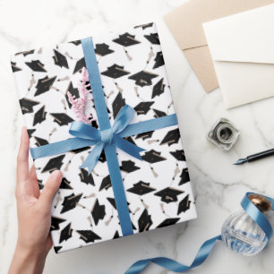 Black Graduation Caps Tossed in the Air on White Wrapping Paper