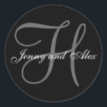 Black Grey Monogram H Bride Groom Names Wedding Classic Round Sticker<br><div class="desc">Elegant wedding sticker with monogram initial of last name and bride and groom names which you can customise with your personal information and wedding colour scheme. A great sticker for wedding favour stickers, cake box labels, wedding treat bag seals, and wedding invitation envelope seals. Design by Elke Clarke ©2008. Use...</div>