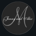 Black Grey Monogram M Bride Groom Names Wedding Classic Round Sticker<br><div class="desc">Elegant wedding sticker with monogram initial of last name and bride and groom names which you can customise with your personal information and wedding colour scheme. A great sticker for wedding favour stickers, cake box labels, wedding treat bag seals, and wedding invitation envelope seals. Design by Elke Clarke ©2008. Use...</div>
