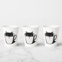 Black kitten with red nose hiding in a cup