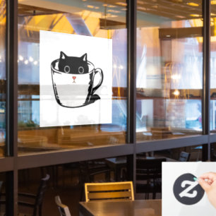 Black kitten with red nose hiding in a cup