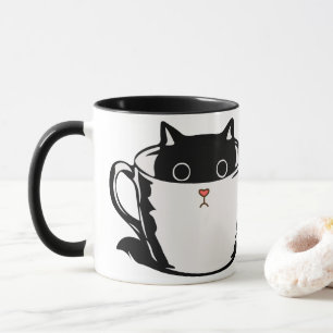 Black kitten with red nose hiding in a cup