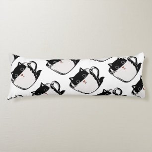 Black kitten with red nose hiding in a cup body cushion