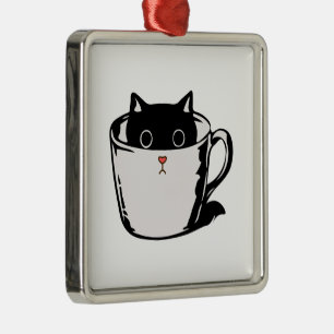 Black kitten with red nose hiding in a cup metal tree decoration