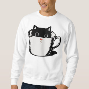 Black kitten with red nose hiding in a cup sweatshirt