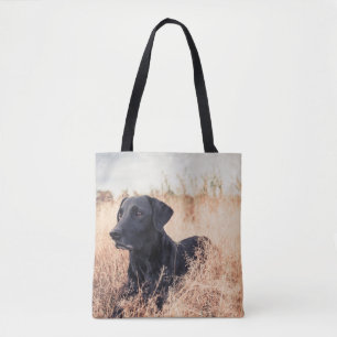 Black Labrador In Dry Grass Tote Bag