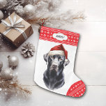 Black Labrador Retriever Santa Hat<br><div class="desc">The front of this Holiday stocking shows an image of a majestic black Labrador Retriever wearing a Santa hat. The image is placed on a white background, and the toe and top border are a red and white snowflake pattern. On the top border is a white label with your custom...</div>