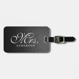 Black leather background monogrammed luggage tag