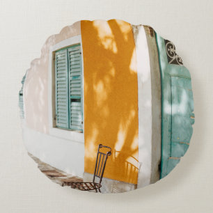 Black metal chair near dor round cushion