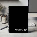 BLACK Minimal Monogram Initial CORPORATE BUSINESS Planner<br><div class="desc">Elevate your daily planning with this modern minimalist notebook, designed in a clean black-and-white color palette that suits both professional and personal use. Your custom name appears in the lower right corner in a refined line-style font, paired with a striking monogram initial created in the distinctive Monoton typeface. With its...</div>