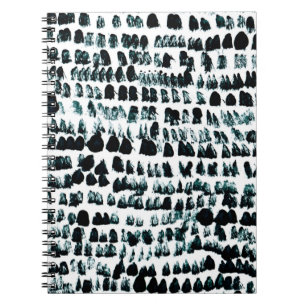 Black paint stains with spots, blots and grains on notebook