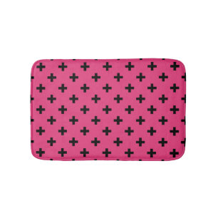 Black polka crosses on fuchsia bath mat