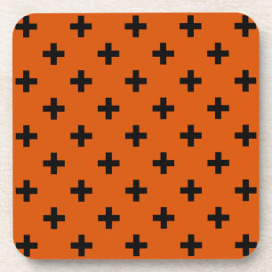 Black polka crosses on orange coaster