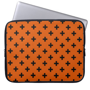 Black polka crosses on orange laptop sleeve